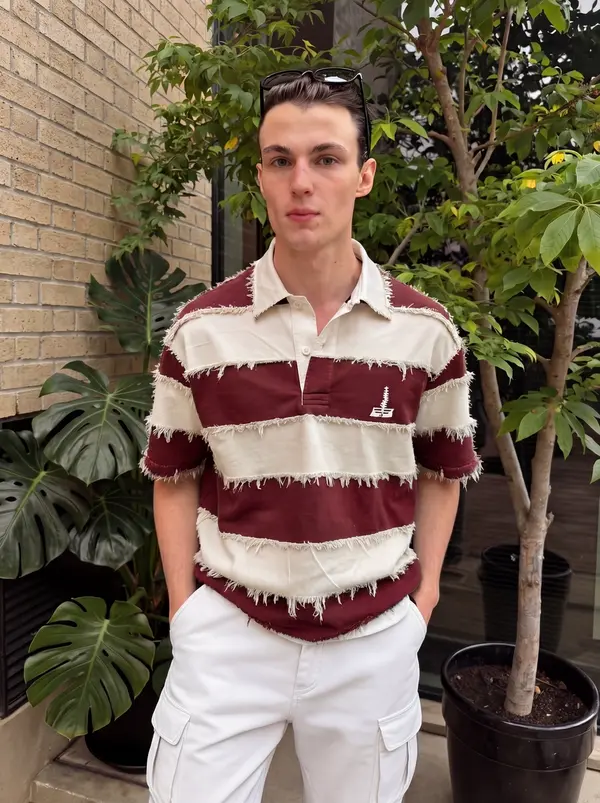 AI actor Niko in a striped polo among plants, from Pixraft Marketing Studio